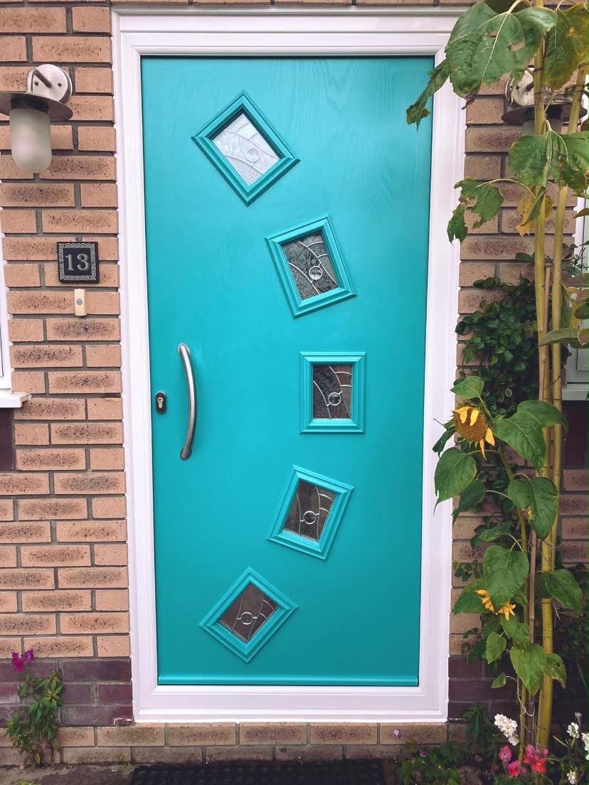 Turquoise composite door with five diamond glazed panels and white frame